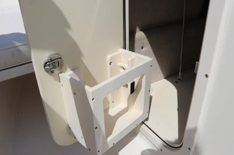 Slide: The Image of 2008 Robalo R227 Dual Console storage compartment with open door and latch. - 39
