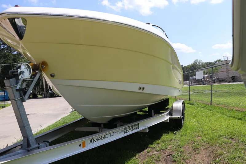 Slide: The Image of 2008 Robalo R227 Dual Console boat on trailer, parked on grass. - 4