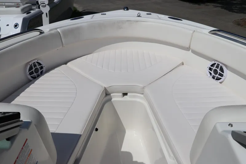 Slide: The Image of 2008 Robalo R227 Dual Console boat with white cushioned seating and speakers. - 42