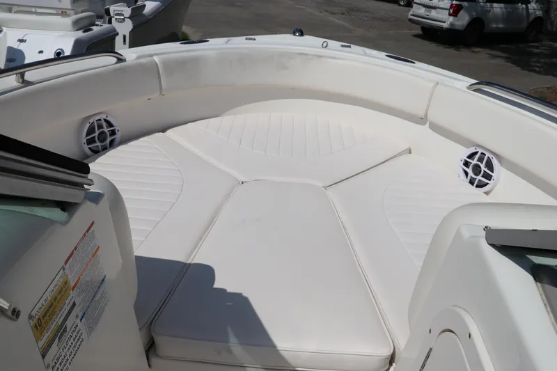 Slide: The Image of 2008 Robalo R227 Dual Console boat with white cushioned seating and speakers. - 43