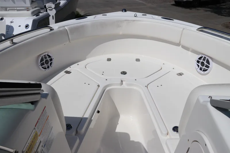 Slide: The Image of 2008 Robalo R227 Dual Console boat interior with white seating and storage compartments. - 44