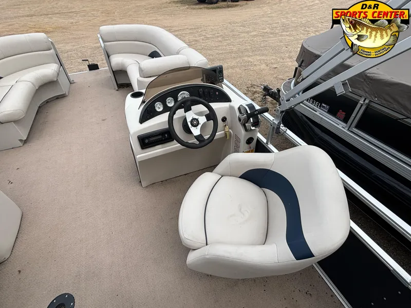Slide: The Image of Cypress Cay 210 Seabreeze 2010 boat interior with steering console and seating. - 5