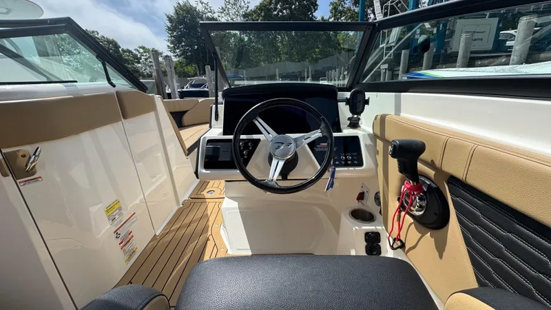 Slide: The Image of 2022 Sea Ray SPX 230 boat cockpit with steering wheel and control panel. - 12