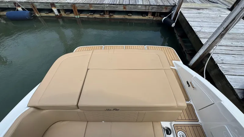 Slide: The Image of 2022 Sea Ray SPX 230 boat with tan seating at a dock. - 4