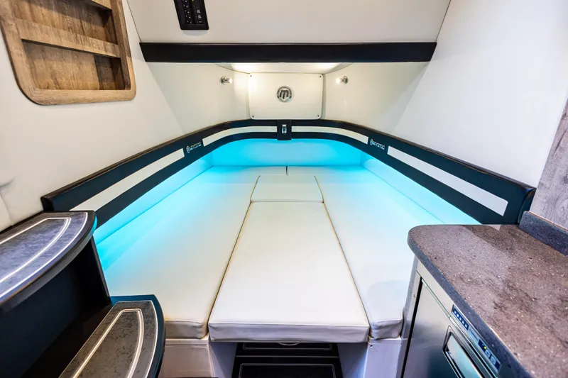 Slide: The Image of Luxurious interior cabin of 2026 Mystic Powerboats M4200 with ambient lighting. - 11