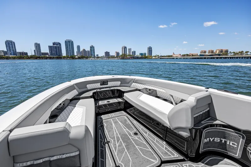 Slide: The Image of 2026 Mystic Powerboats M4200 on water with city skyline in background. - 17
