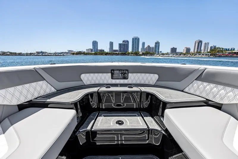 Slide: The Image of 2026 Mystic Powerboats M4200 interior with city skyline view, luxurious seating, and modern design. - 20