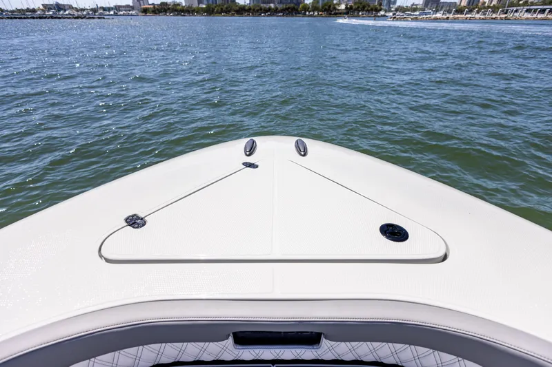 Slide: The Image of Bow view of 2026 Mystic Powerboats M4200 on water, showcasing sleek design. - 21