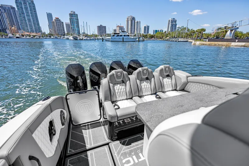 Slide: The Image of 2026 Mystic Powerboats M4200 luxury boat interior with city skyline in background. - 24