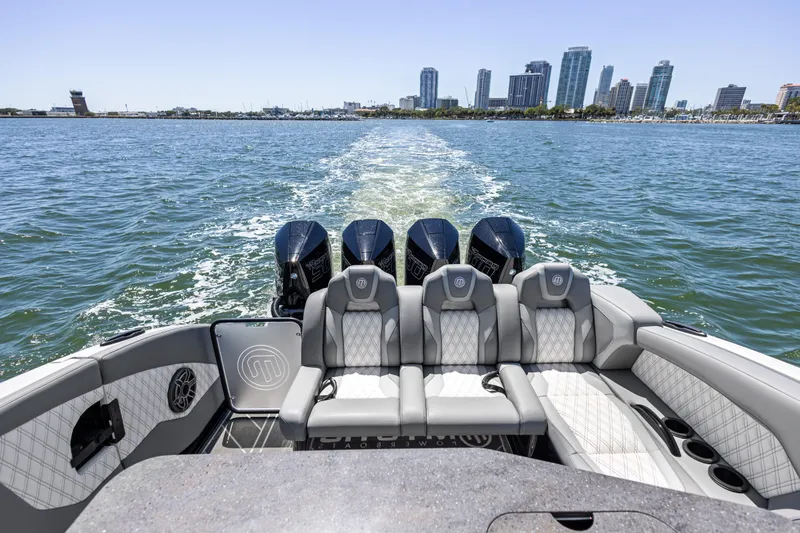 Slide: The Image of 2026 Mystic Powerboats M4200 cruising with city skyline in background. - 29