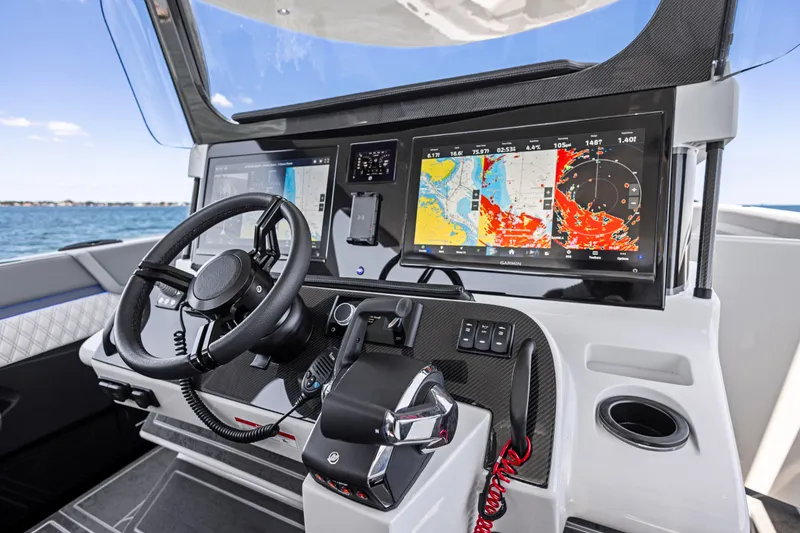 Slide: The Image of Cockpit of 2026 Mystic Powerboats M4200 with advanced navigation displays and steering wheel. - 32