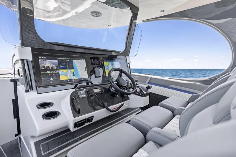 Slide: The Image of 2026 Mystic Powerboats M4200 helm with advanced navigation screens and luxurious seating. - 38
