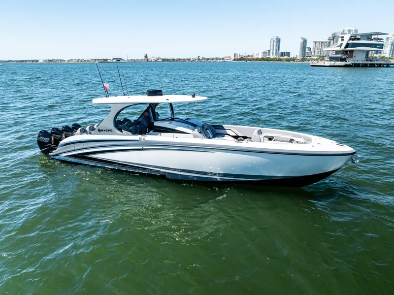 Slide: The Image of 2026 Mystic Powerboats M4200 cruising on water near city skyline. - 41