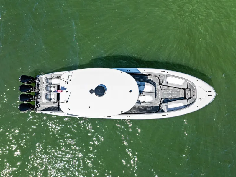 Slide: The Image of Top view of 2026 Mystic Powerboats M4200 on green water, showcasing sleek design and powerful engines. - 44