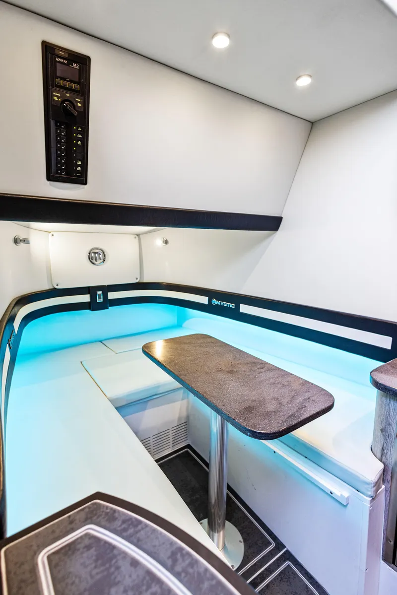 Slide: The Image of Interior of 2026 Mystic Powerboats M4200 with modern seating and ambient lighting. - 9