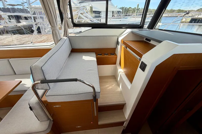 Slide: The Image of Interior of 2026 Beneteau Swift Trawler 37 Fly, featuring modern seating and wood accents. - 22
