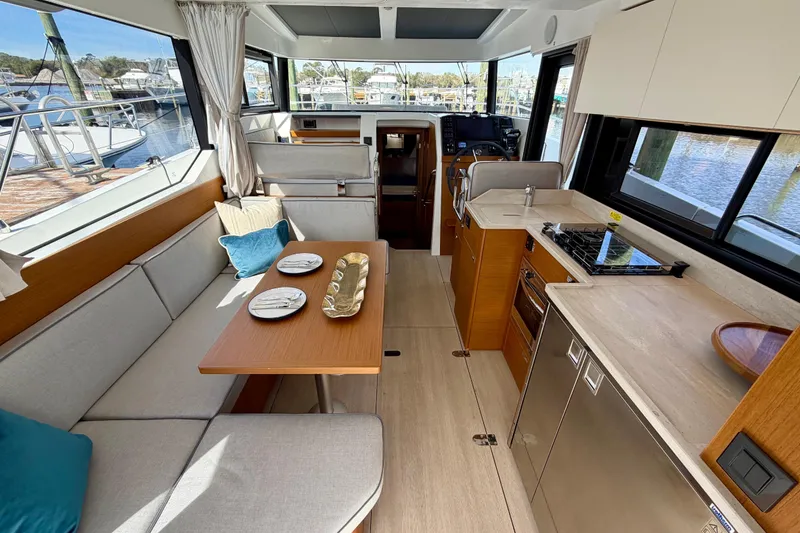 Slide: The Image of Interior of 2026 Beneteau Swift Trawler 37 Fly, featuring modern kitchen and dining area. - 24
