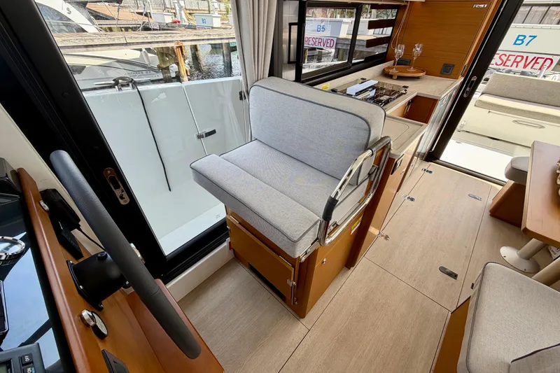 Slide: The Image of 2026 Beneteau Swift Trawler 37 Fly interior with helm station and seating area. - 27