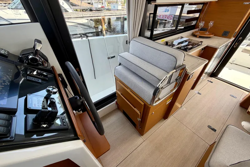 Slide: The Image of Interior of 2026 Beneteau Swift Trawler 37 Fly, featuring helm and seating area. - 28