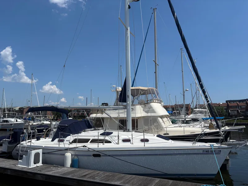 Slide: The Image of 2006 Catalina 350 sailboat docked at a marina under a clear blue sky. - 1
