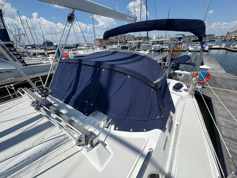 Slide: The Image of Catalina 350 sailboat, 2006 model, docked at marina with blue canvas cover. - 12