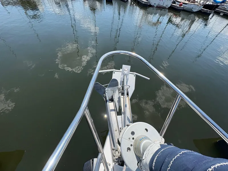 Slide: The Image of Bow of a 2006 Catalina 350 sailboat with anchor and winch, docked in a marina. - 15