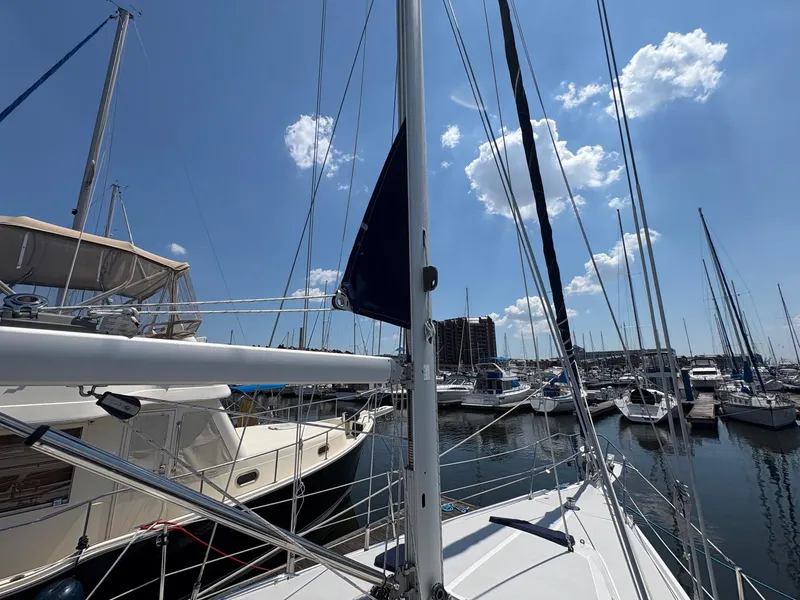Slide: The Image of Sailboats docked at a marina under a clear blue sky, featuring a 2006 Catalina 350. - 18
