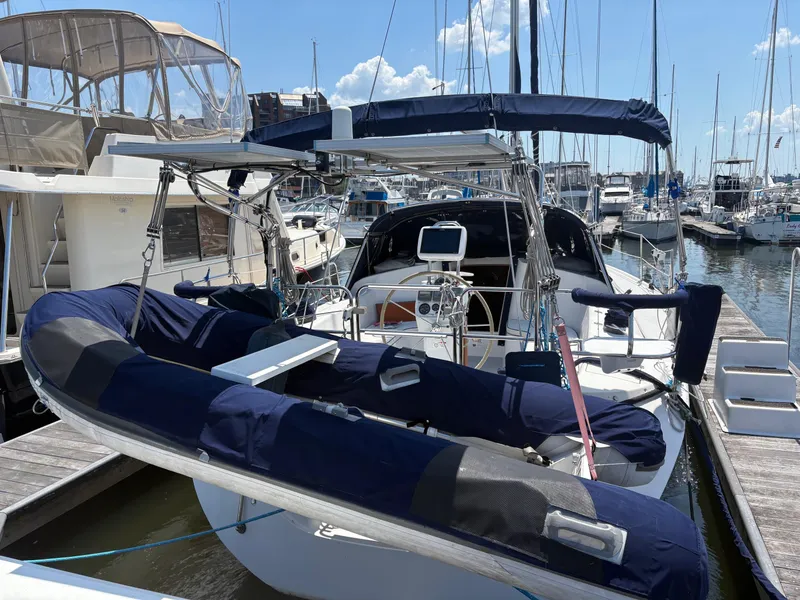 Slide: The Image of Catalina 350 sailboat, 2006 model, docked at marina with blue covers and clear sky. - 2