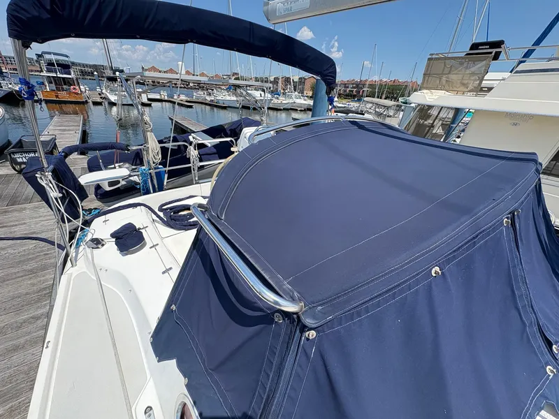 Slide: The Image of Catalina 350 sailboat, 2006 model, docked at marina with blue canvas cover. - 20