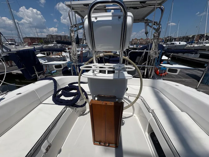 Slide: The Image of Catalina 350 sailboat cockpit with steering wheel, docked in marina, clear sky. - 21