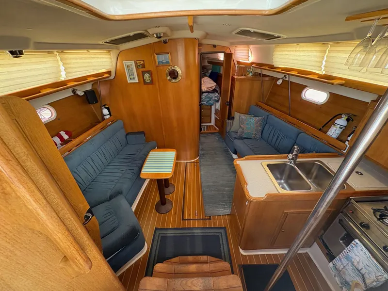Slide: The Image of Interior of 2006 Catalina 350 sailboat with cozy seating and kitchen area. - 22