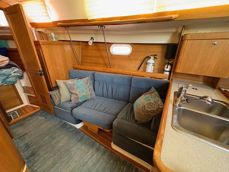 Slide: The Image of Interior of a 2006 Catalina 350 sailboat with cozy seating and kitchenette. - 24