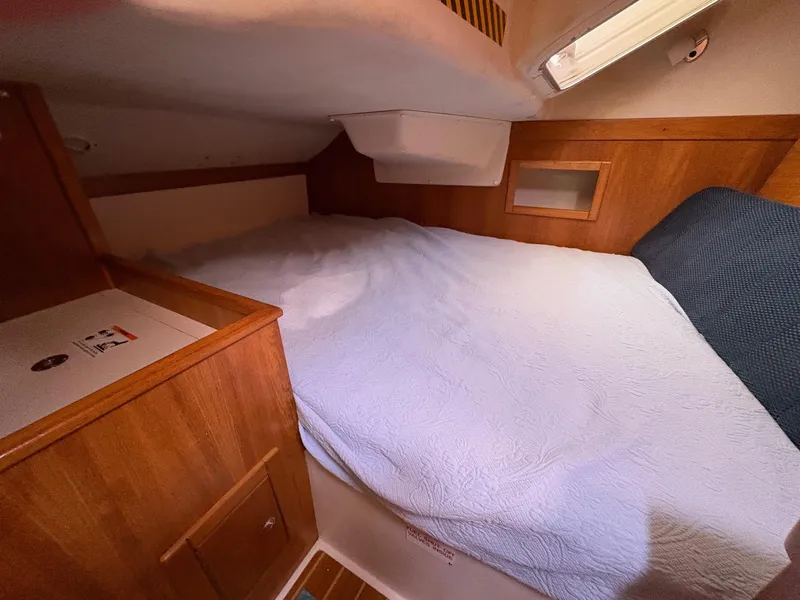 Slide: The Image of Cozy cabin interior of a 2006 Catalina 350 sailboat with wooden accents and a comfortable bed. - 29