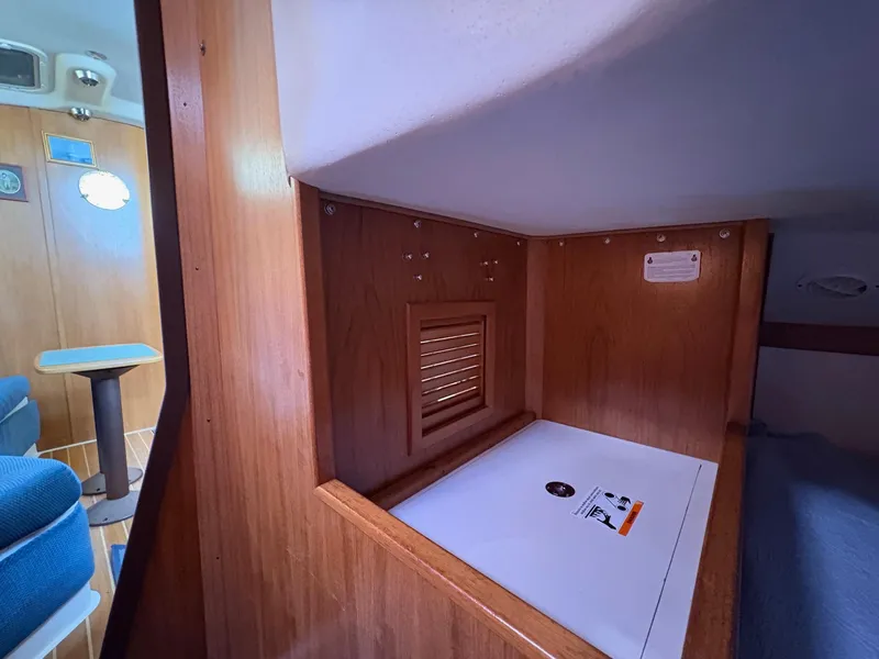 Slide: The Image of Interior of a 2006 Catalina 350 sailboat, featuring wood paneling and seating area. - 30