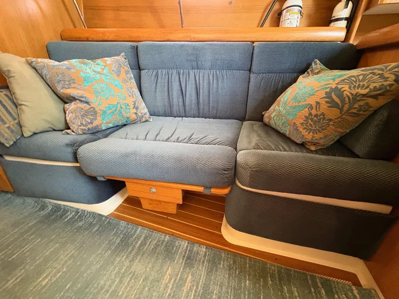 Slide: The Image of Cozy seating area in a 2006 Catalina 350 sailboat with decorative cushions. - 32