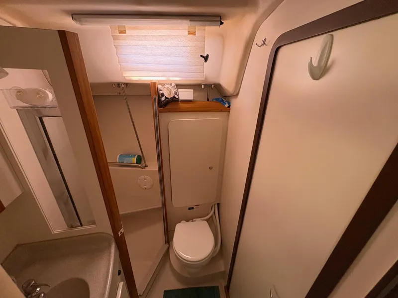 Slide: The Image of Bathroom interior of a 2006 Catalina 350 sailboat, featuring a compact design. - 35