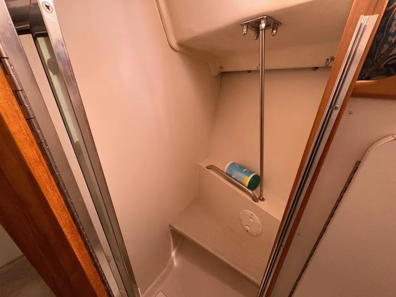 Slide: The Image of 2006 Catalina 350 interior shower area with storage shelf and metal rail. - 37