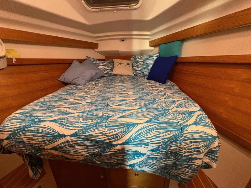 Slide: The Image of Cozy cabin bed in 2006 Catalina 350 sailboat with blue patterned bedding. - 39