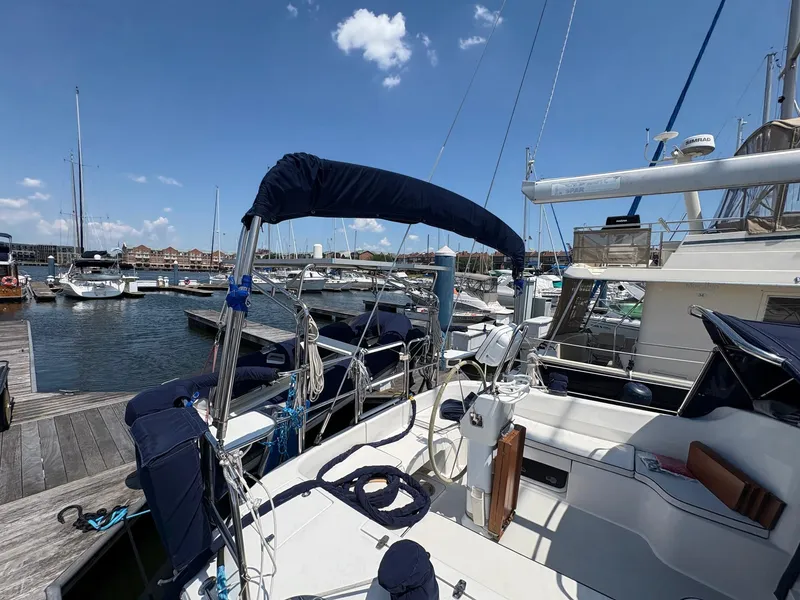 Slide: The Image of 2006 Catalina 350 sailboat docked at marina under clear blue sky. - 4