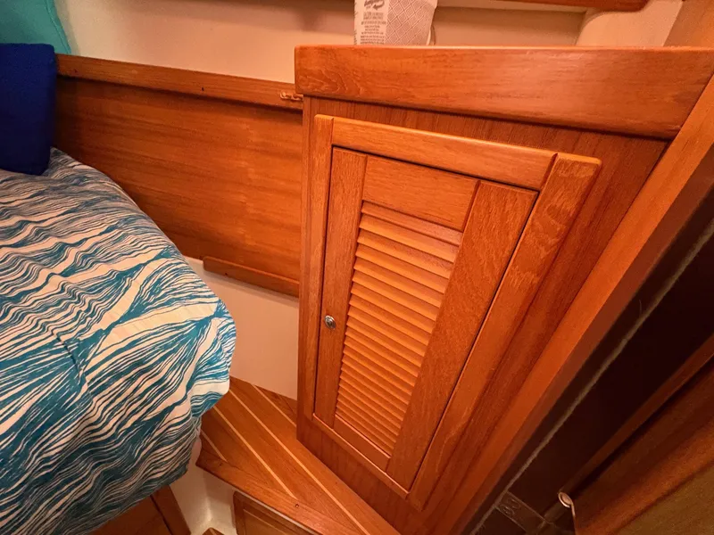 Slide: The Image of Wooden interior of 2006 Catalina 350 sailboat with bed and storage cabinet. - 40