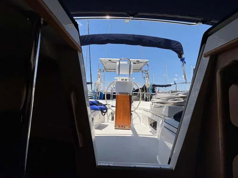 Slide: The Image of Interior view of a 2006 Catalina 350 sailboat cockpit with steering wheel and seating. - 44