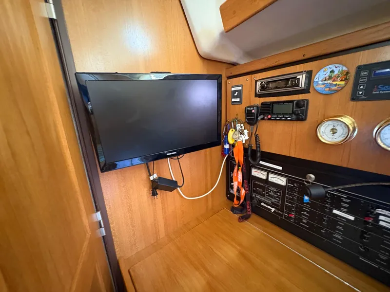 Slide: The Image of Interior of a 2006 Catalina 350 yacht with navigation equipment and mounted TV. - 47