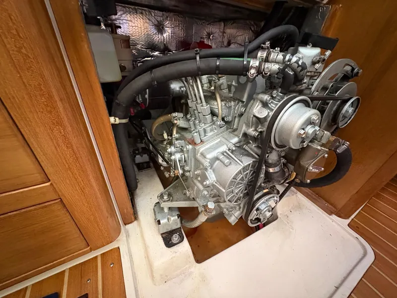 Slide: The Image of Engine compartment of a 2006 Catalina 350 sailboat, showcasing detailed mechanical components. - 49