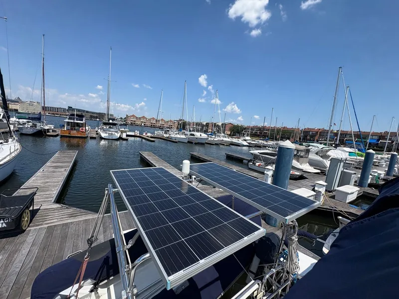 Slide: The Image of Catalina 350 sailboat with solar panels docked at a marina, clear sky background. - 5