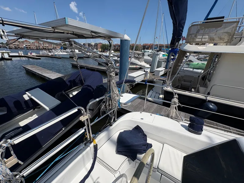 Slide: The Image of Catalina 350 sailboat docked at marina, showcasing deck and rigging, clear blue sky. - 7