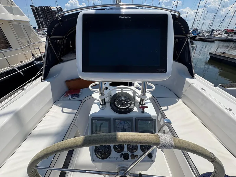 Slide: The Image of Cockpit of a 2006 Catalina 350 sailboat with navigation equipment and steering wheel. - 9