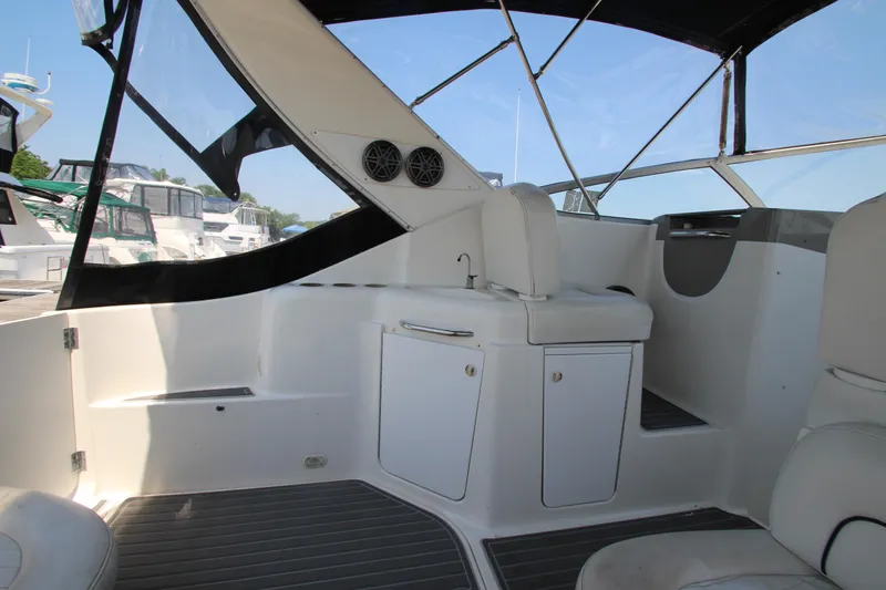 Slide: The Image of 1999 Bayliner 3055 Ciera boat interior with seating and storage, docked at marina. - 10