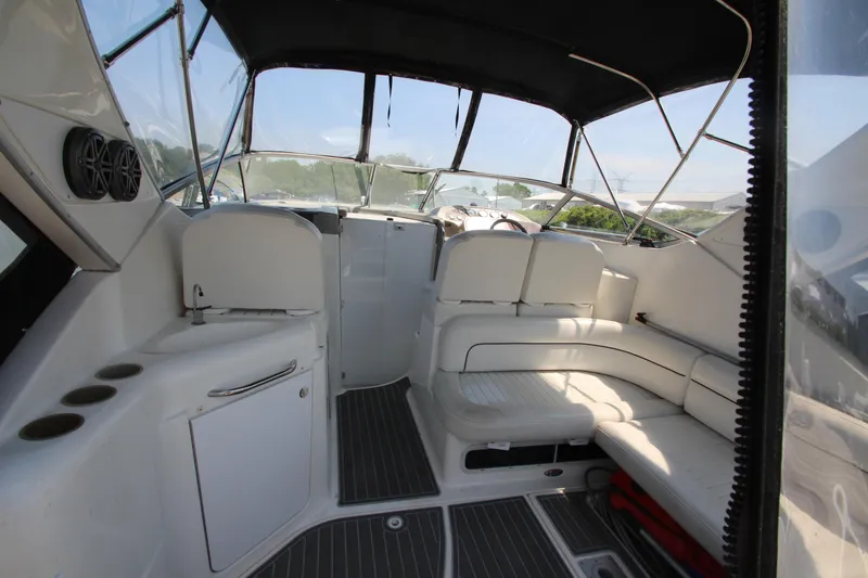 Slide: The Image of 1999 Bayliner 3055 Ciera boat interior with white seating and modern amenities. - 11