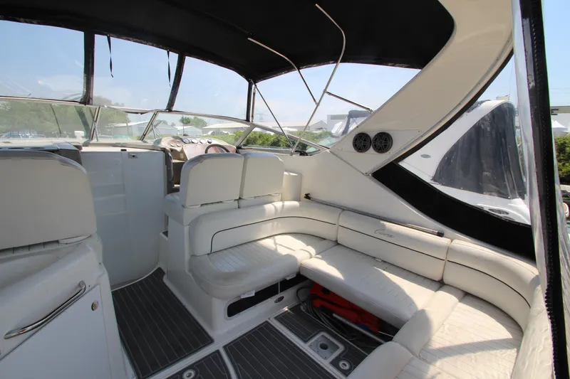 Slide: The Image of 1999 Bayliner 3055 Ciera interior with white seating and black canopy. - 12