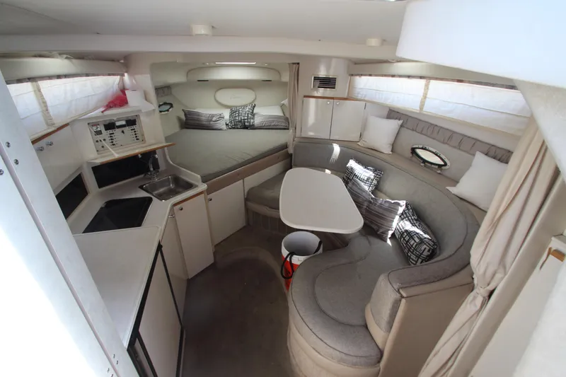 Slide: The Image of Interior of 1999 Bayliner 3055 Ciera with cozy seating and compact kitchen area. - 15